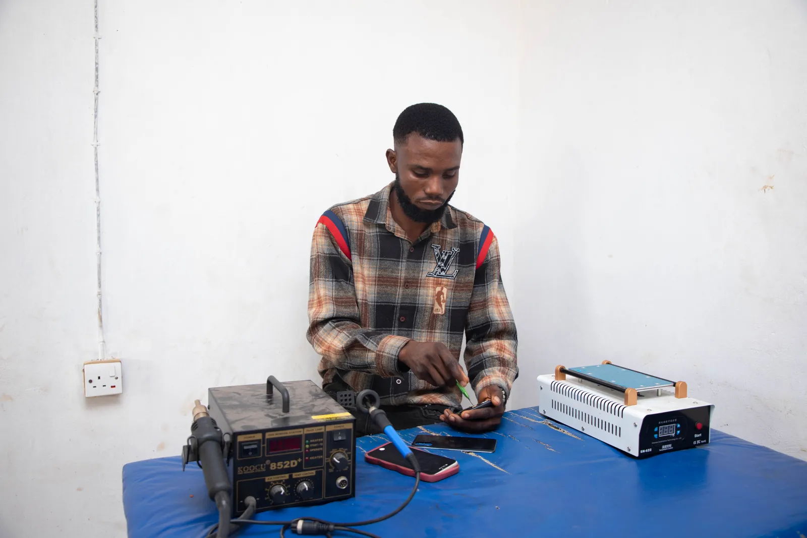 DR-TB Survivor, Kazeem O at work in his shop in Ifedore, Ondo State.